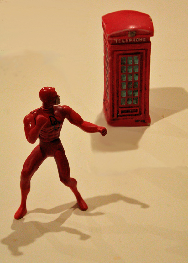 Daredevil is wary of who might be in the phone booth behind him.